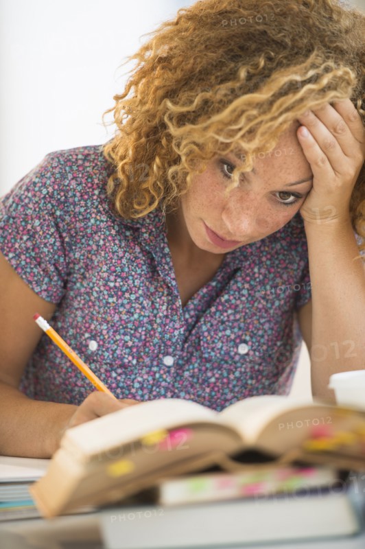 Young woman studying in library.