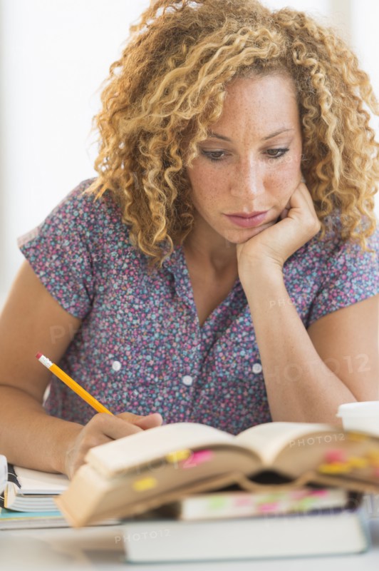 Young woman studying in library.