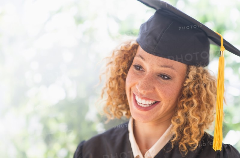 Portrait of smiling young woman in mortarboard.