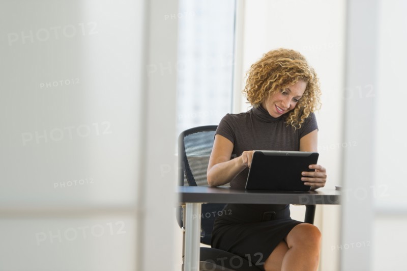 Businesswoman working at desk in office.