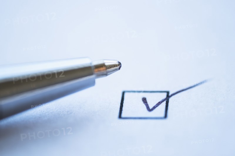 Close up of pen and checkbox sign, studio shot.