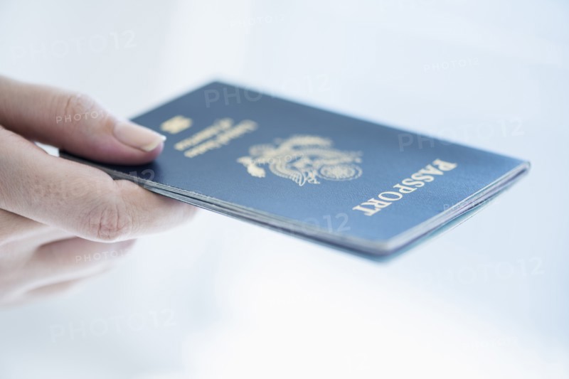 Close up of woman's hand holding passport.