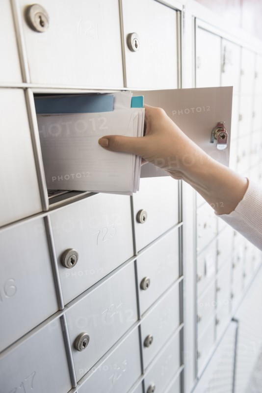 Woman taking letters from safety deposit box.