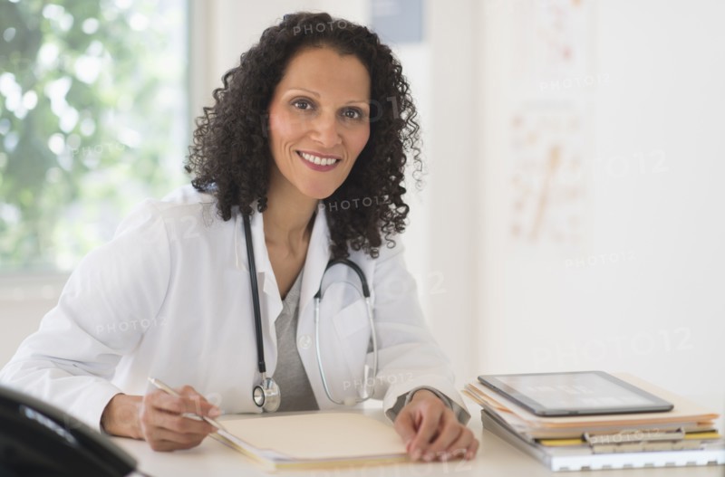 Portrait of doctor sitting in office.