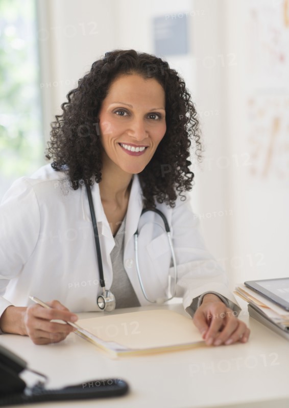 Portrait of doctor sitting in office.