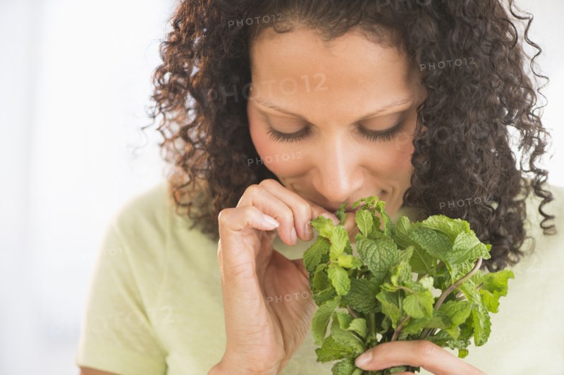 Woman smelling fresh mint.