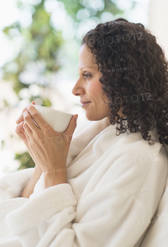 Woman relaxing with cup of coffee.