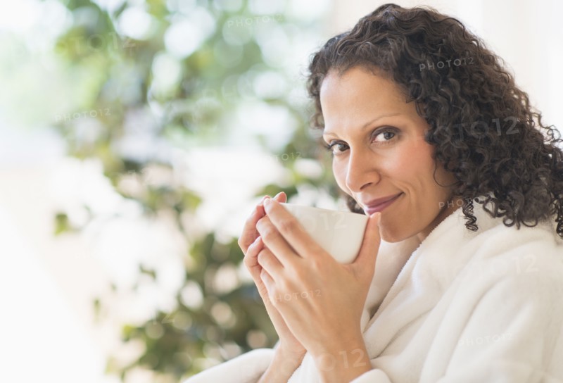 Woman relaxing with cup of coffee.