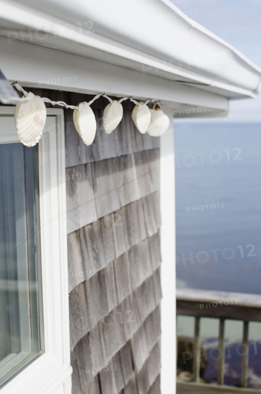 Shell decoration hanging on summer house on coast. Photo: Jamie Grill