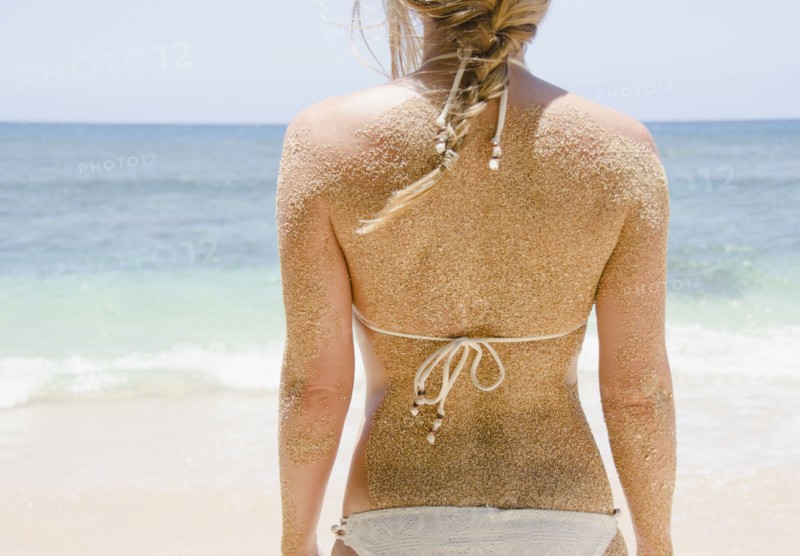 Woman's back with sticking sand . Photo: Jamie Grill