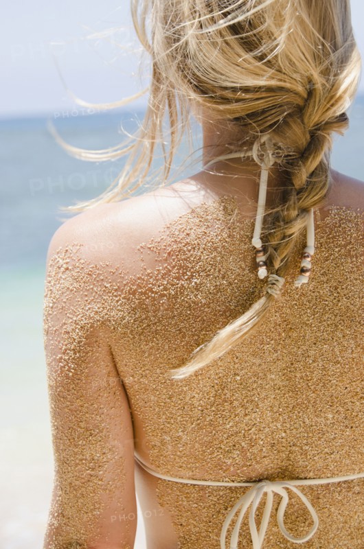 Woman's back with sticking sand . Photo: Jamie Grill