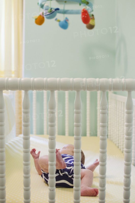 Baby girl (2-5 months) in crib. Photo : Jamie Grill
