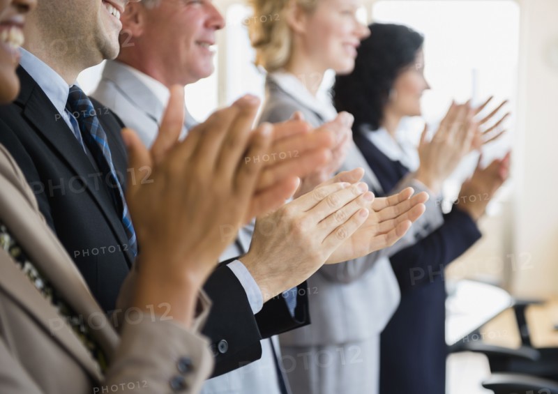 Office workers applauding. Photo: Jamie Grill