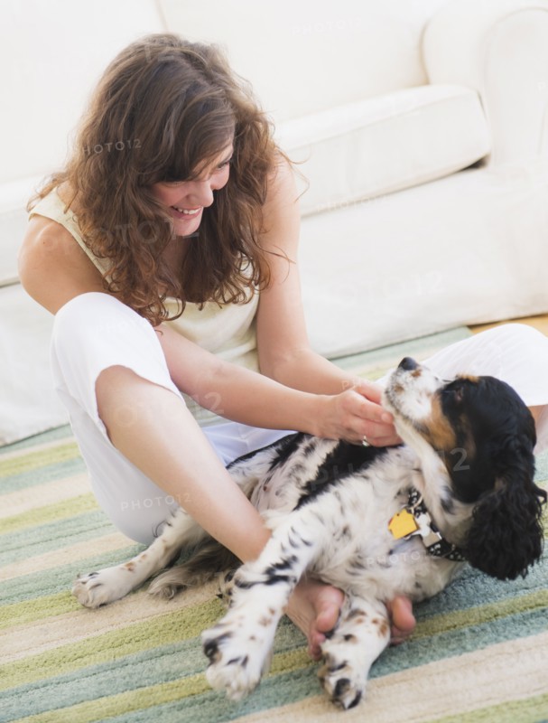 Portrait of young woman playing with dog. Photo: Daniel Grill