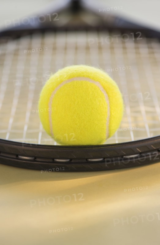 Studio Shot of tennis racket with ball. Photo : Daniel Grill