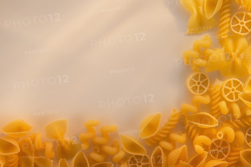 Variety of yellow pasta with blank white space in upper left corner. Photo: Daniel Grill