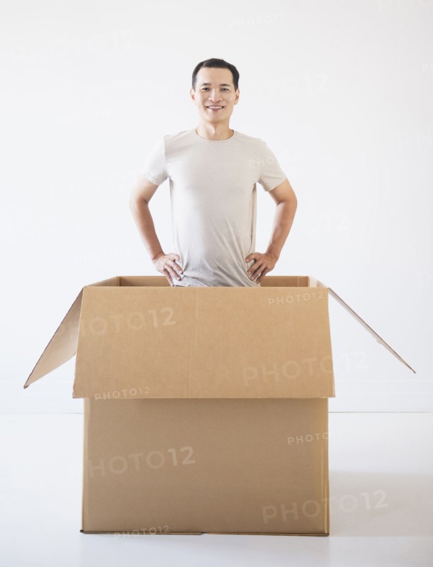 Man popping out from cardboard box. Photo: Daniel Grill