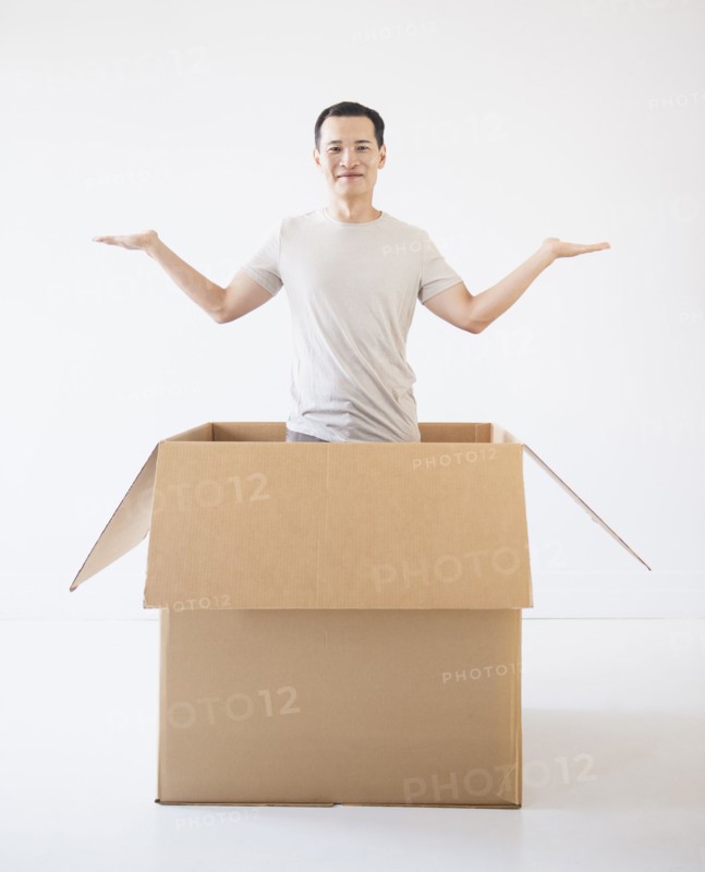 Man popping out from cardboard box. Photo: Daniel Grill
