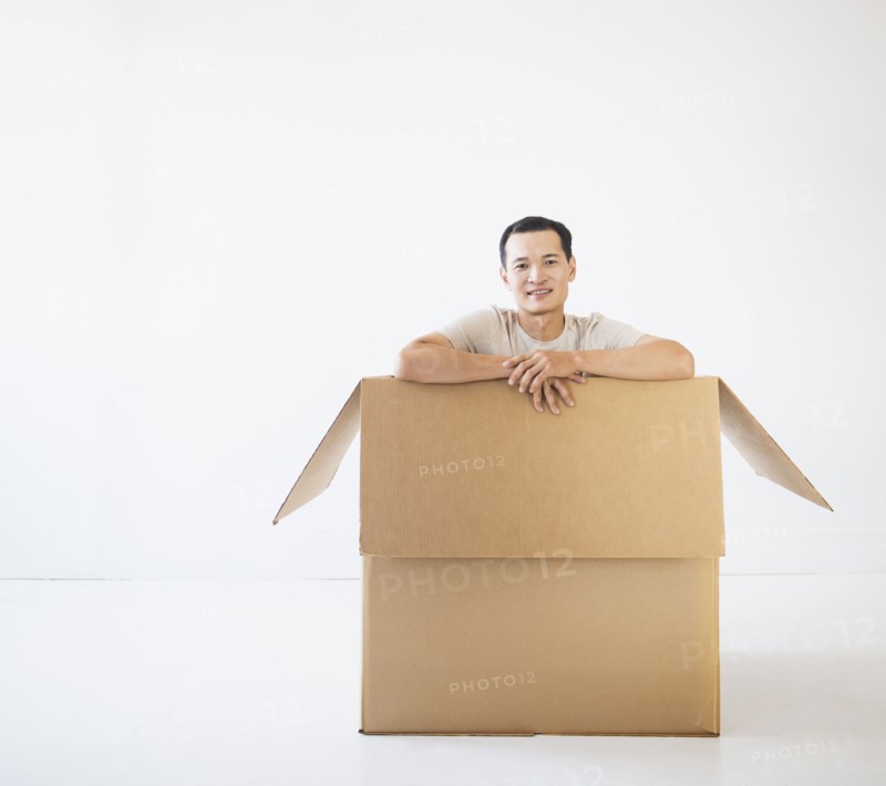 Man sitting in cardboard box. Photo: Daniel Grill