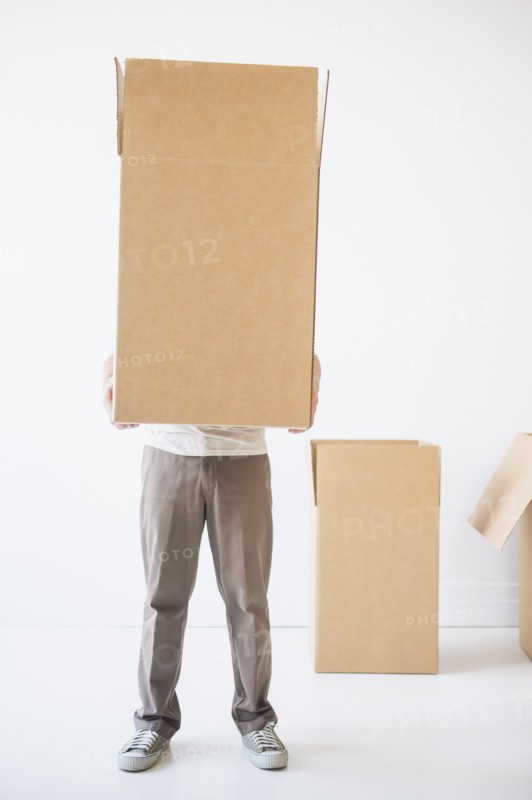 Mid adult man hiding inside of cardboard box. Photo: Daniel Grill
