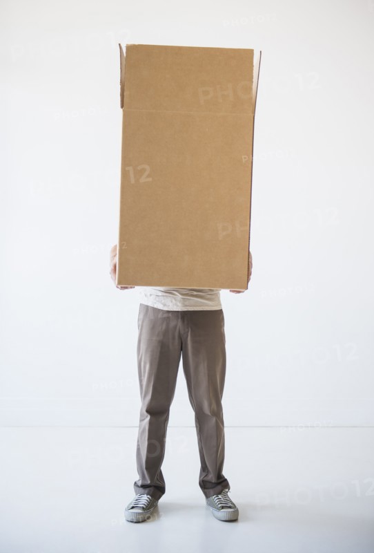 Mid adult man hiding inside of cardboard box. Photo: Daniel Grill