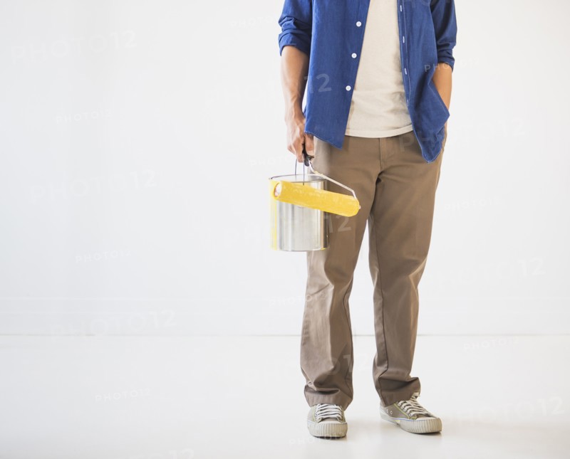 Man holding painting roll. Photo: Daniel Grill