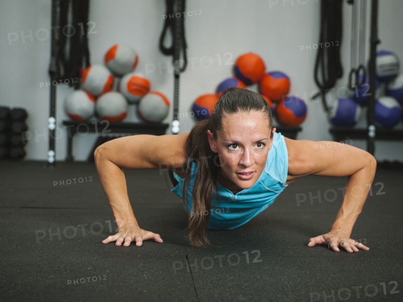 Mad adult woman doing push-ups.