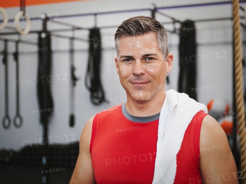 Mature man posing in gym exercising.