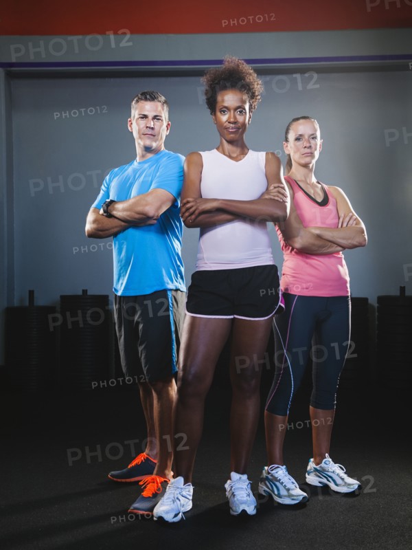 Portrait of three people in gym.