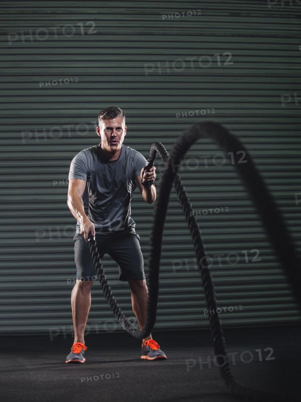 Mature man exercising with rope.