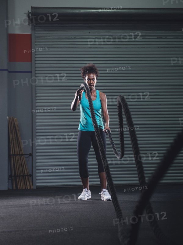 Mid adult woman exercising with rope.