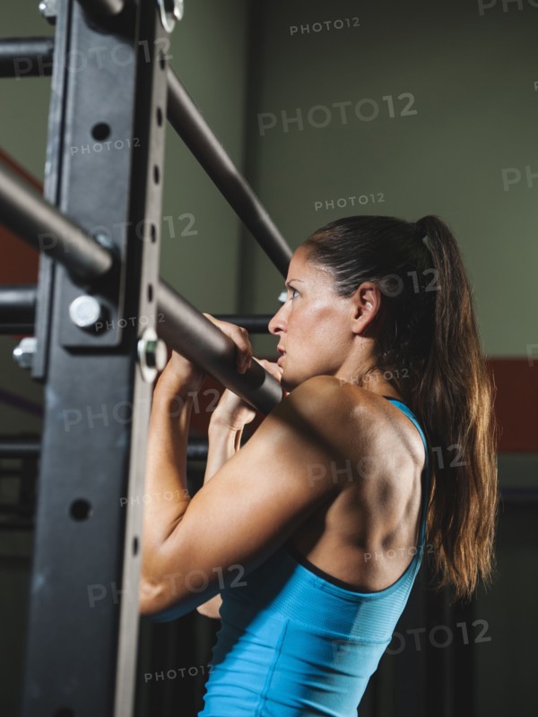 Mid adult woman pulling her up .