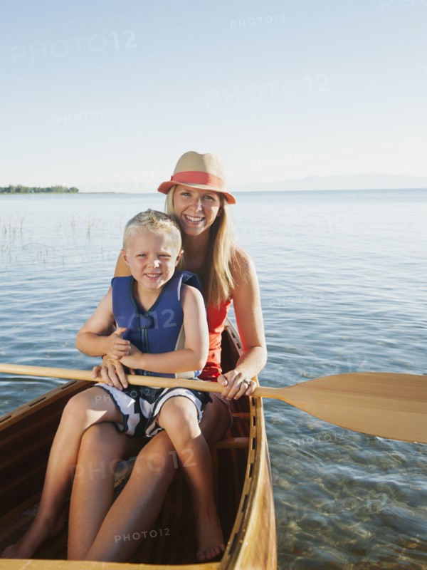 Portrait of young woman with son (4-5) canoe traveling.
