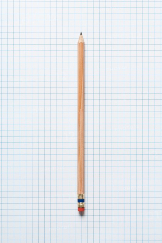 Single wooden sharpened pencil on graph paper. Photo : Kristin Duvall