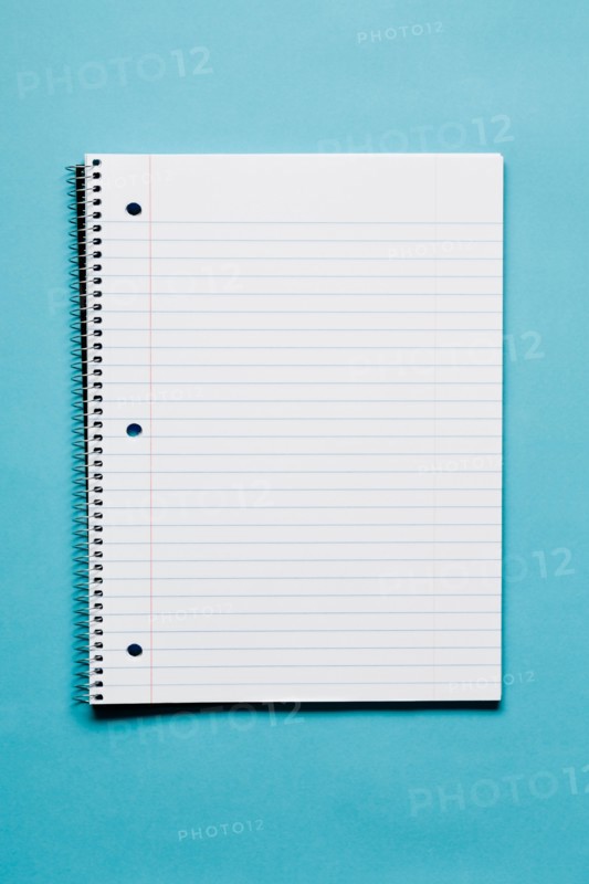 Blank spiral notebook on blue background. Photo: Kristin Duvall
