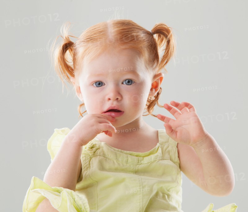 Studio shot of Beautiful Redhead toddler girl looking at camera. Photo: Mike Kemp