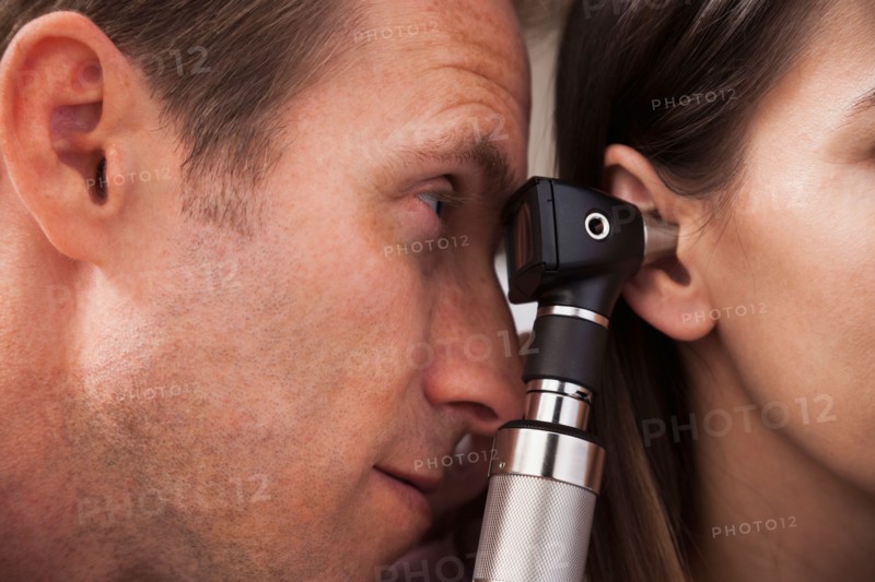 Close-up of doctor doing ear exam with Otoscope. Photo: Mike Kemp