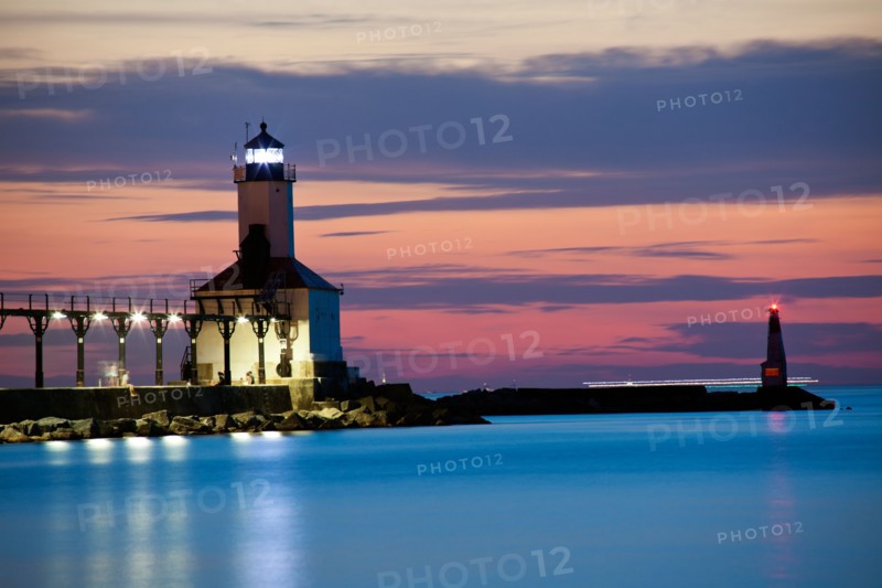 Michigan City Lighthouse at sunset. Chicago skyscrapers seen far in background.. Photo : Henryk Sadura