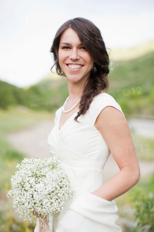 Portrait of smiling woman in white dress. Photo : Jessica Peterson
