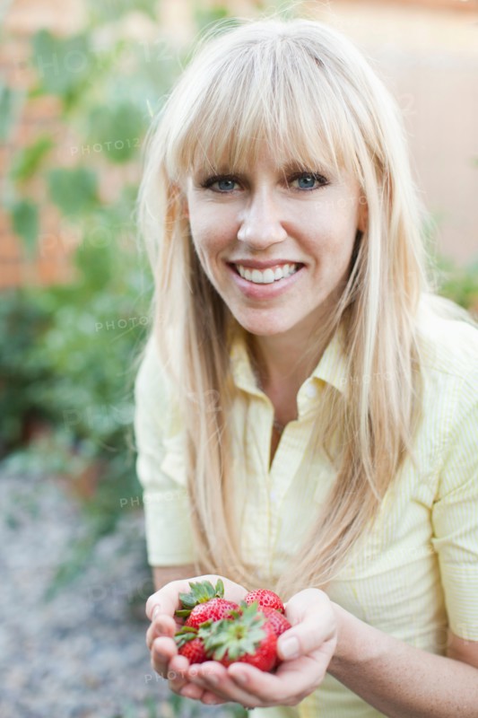 Woman holding strawberries. Photo: Jessica Peterson