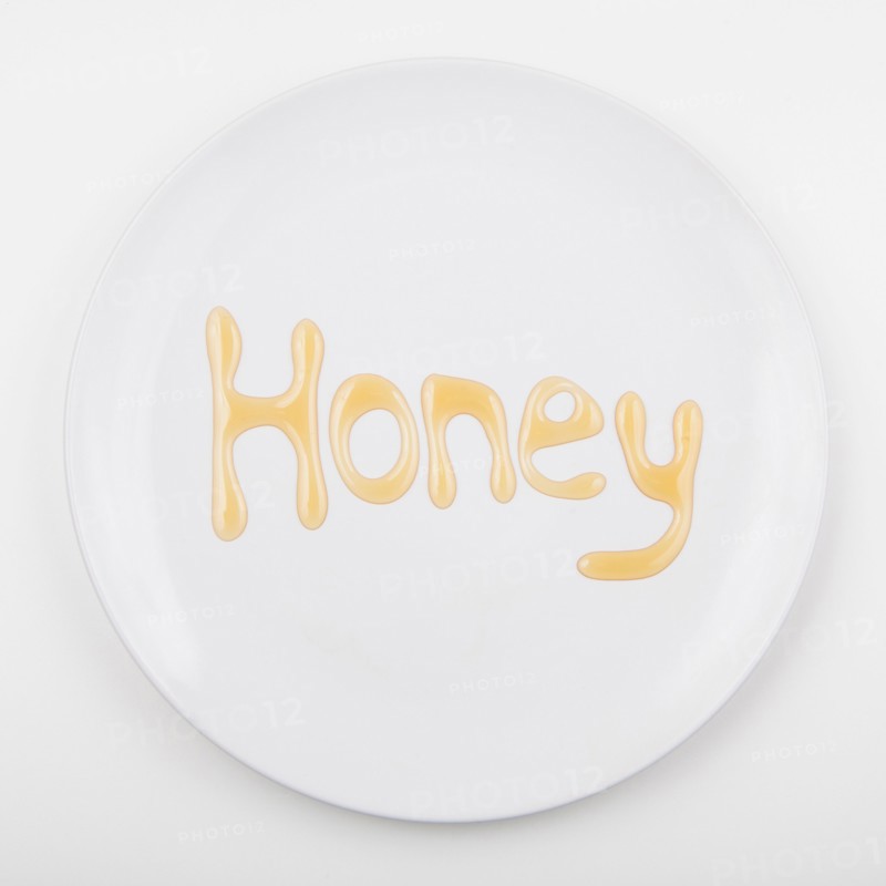 Word HONEY on white plate. Photo: Jessica Peterson