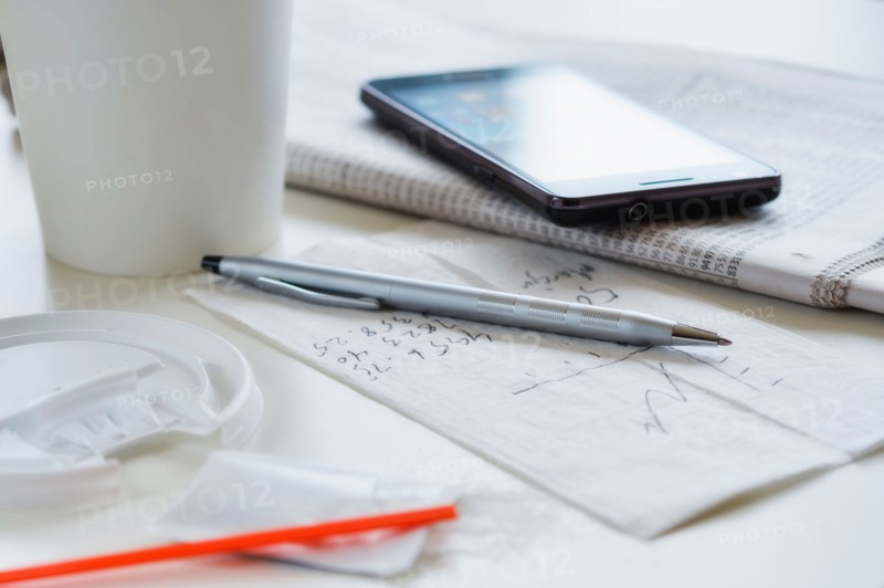 Coffee, smartphone and papers.