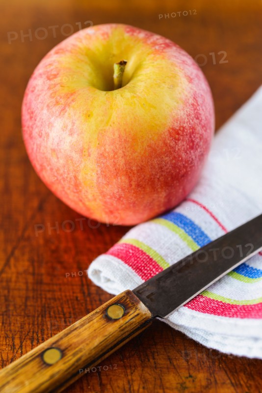 Apple, cloth and knife.
