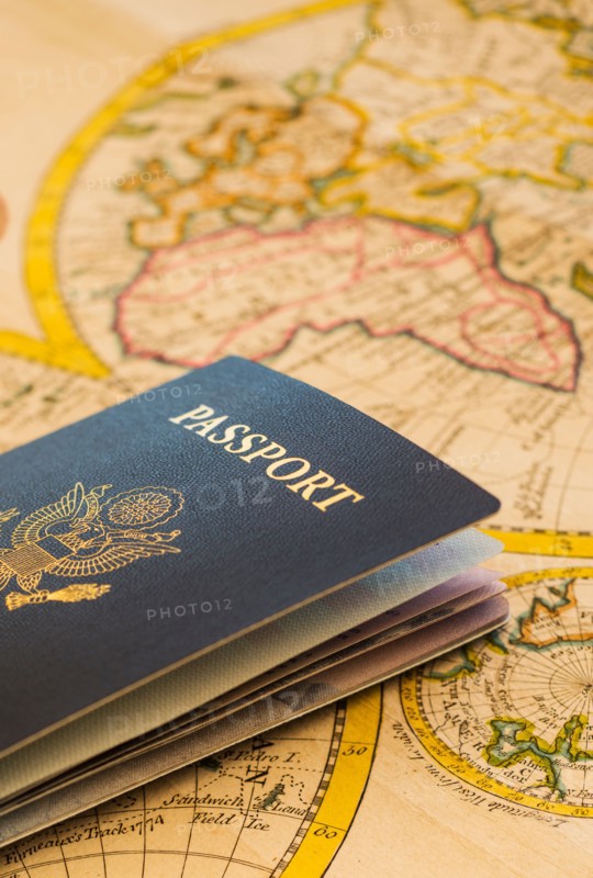 Passport sitting on antique map.