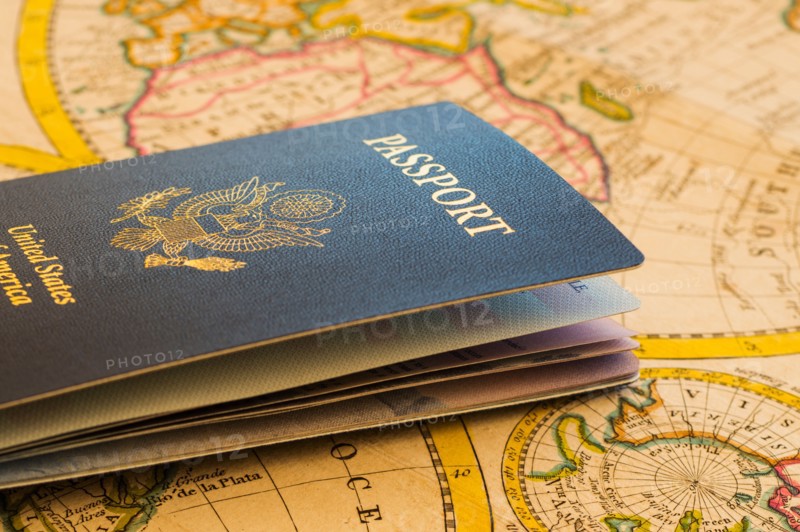 Passport sitting on antique map.