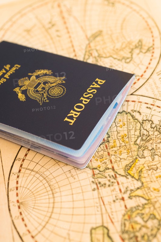 Passport sitting on antique map.