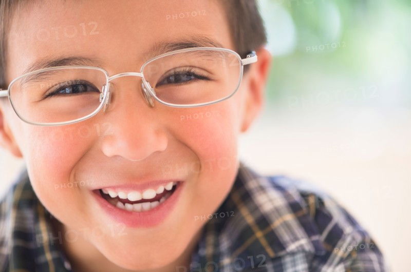 Portrait of boy (6-7) wearing glasses.