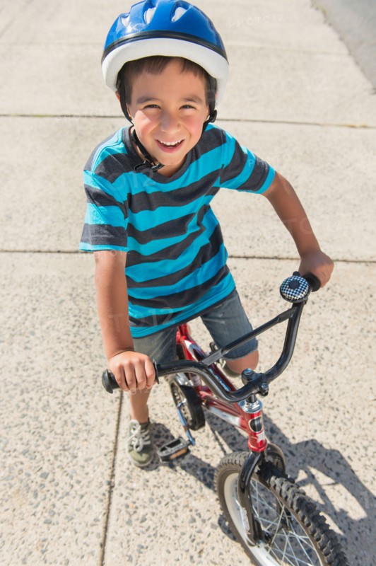 Portrait of boy (6-7) riding bicycle.