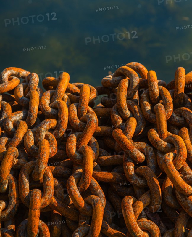 Rusty chains in harbor.
