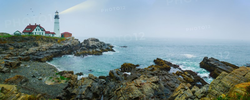 Remote coastline with lighthouse. Portland, Maine.